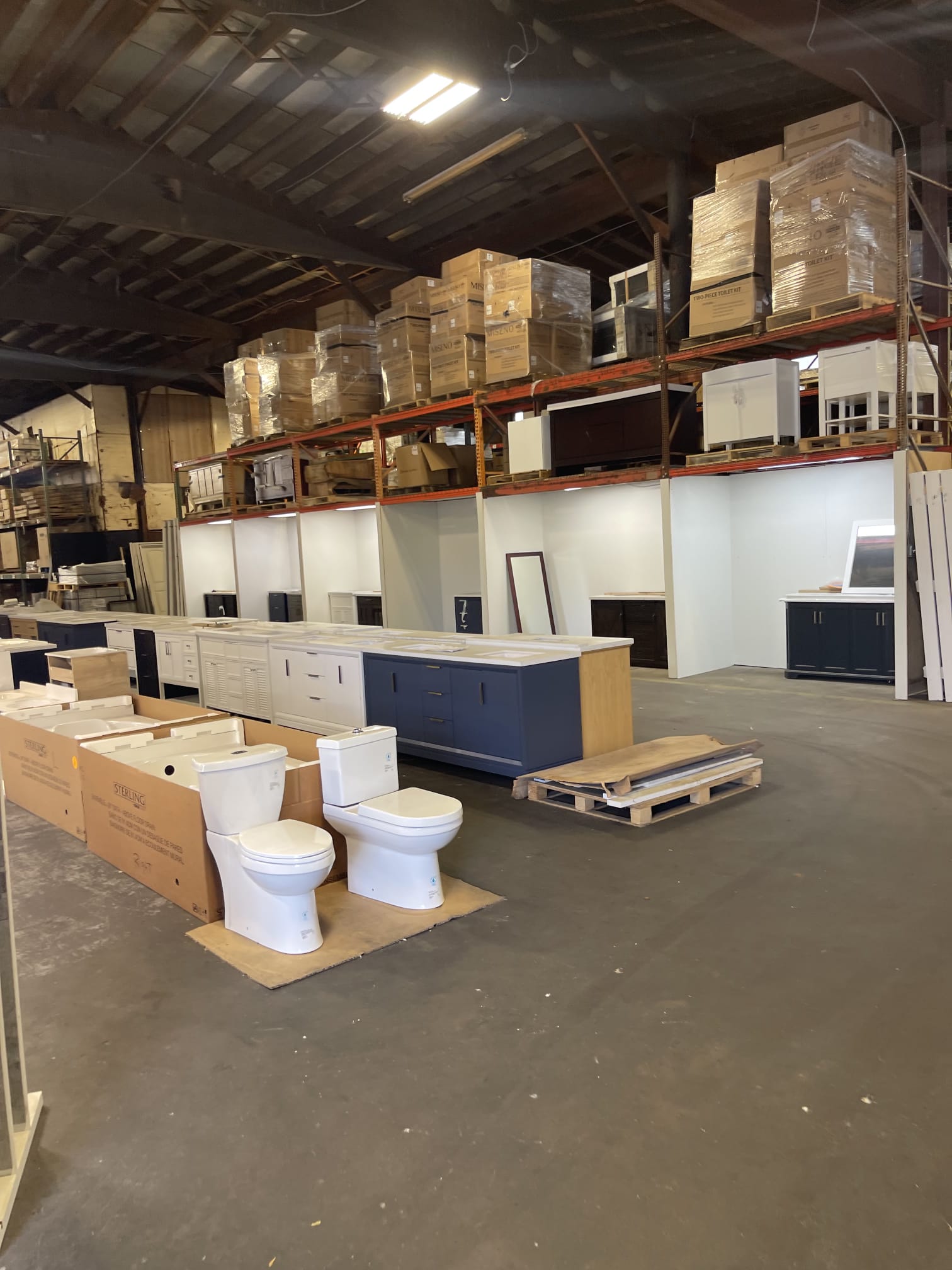 Bathroom vanities and fixtures staged in the Millhurst Trading warehouse