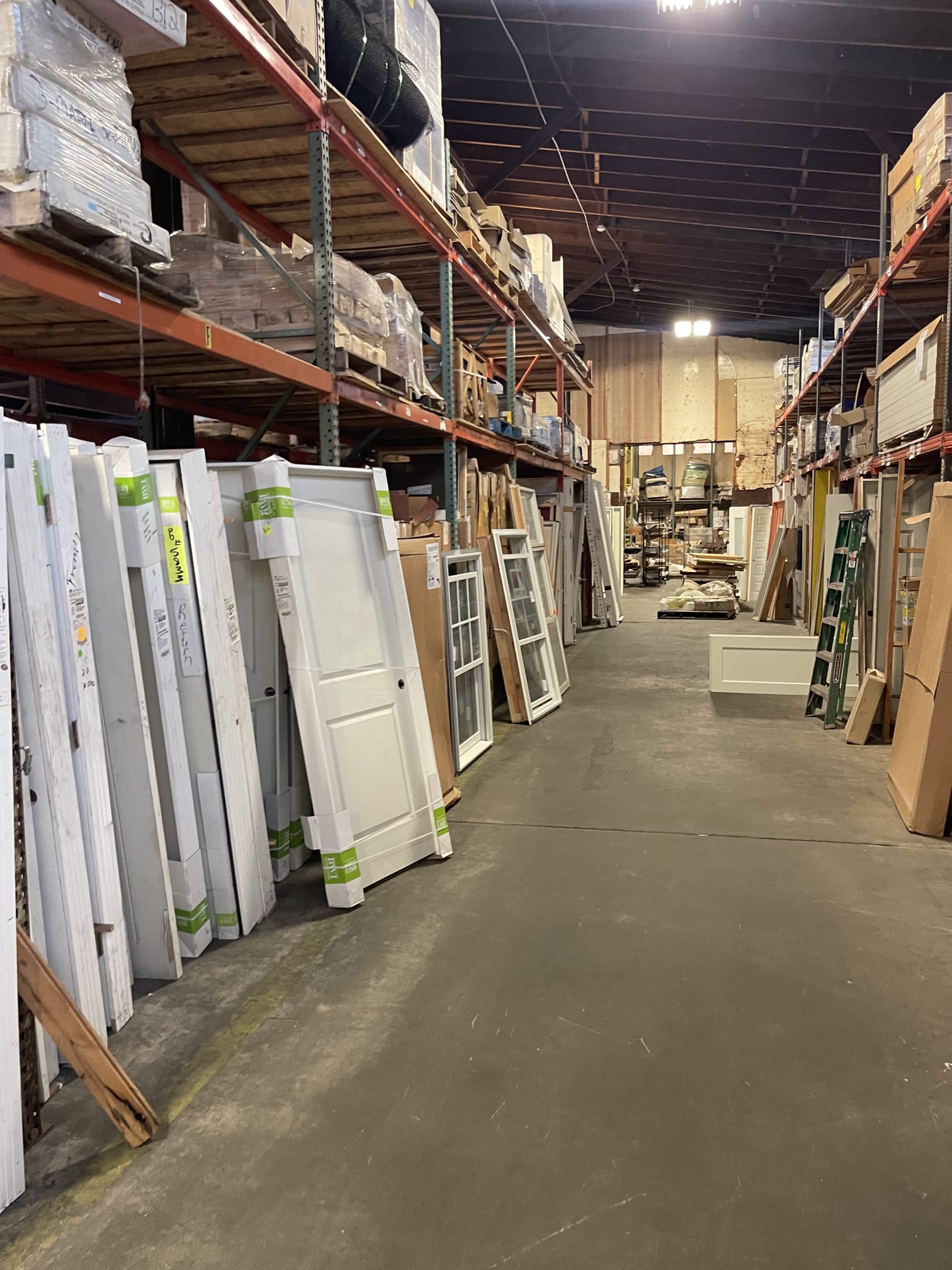 Aisles of entry doors and windows inside the Millhurst Trading warehouse
